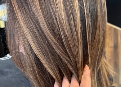 Hand showcasing fresh highlights at Tjf Hair in Melbourne, Victoria, AU.