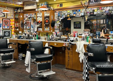 Vintage barber chairs at The Outro Barbershop in 서울특별시, 서울특별시, KR, showcasing a vibrant, eclectic decor.
