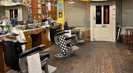 Cozy interior of The Outro Barbershop in 서울특별시, KR with vintage chairs and classic decor.
