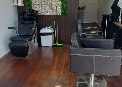 Modern salon interior at Jodie's hair room, Woodville Park, South Australia, AU with stylish chairs.