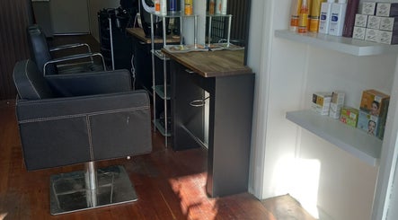Modern salon setup at Jodie's Hair Room in Woodville Park, South Australia, AU with sleek chairs and beauty products.