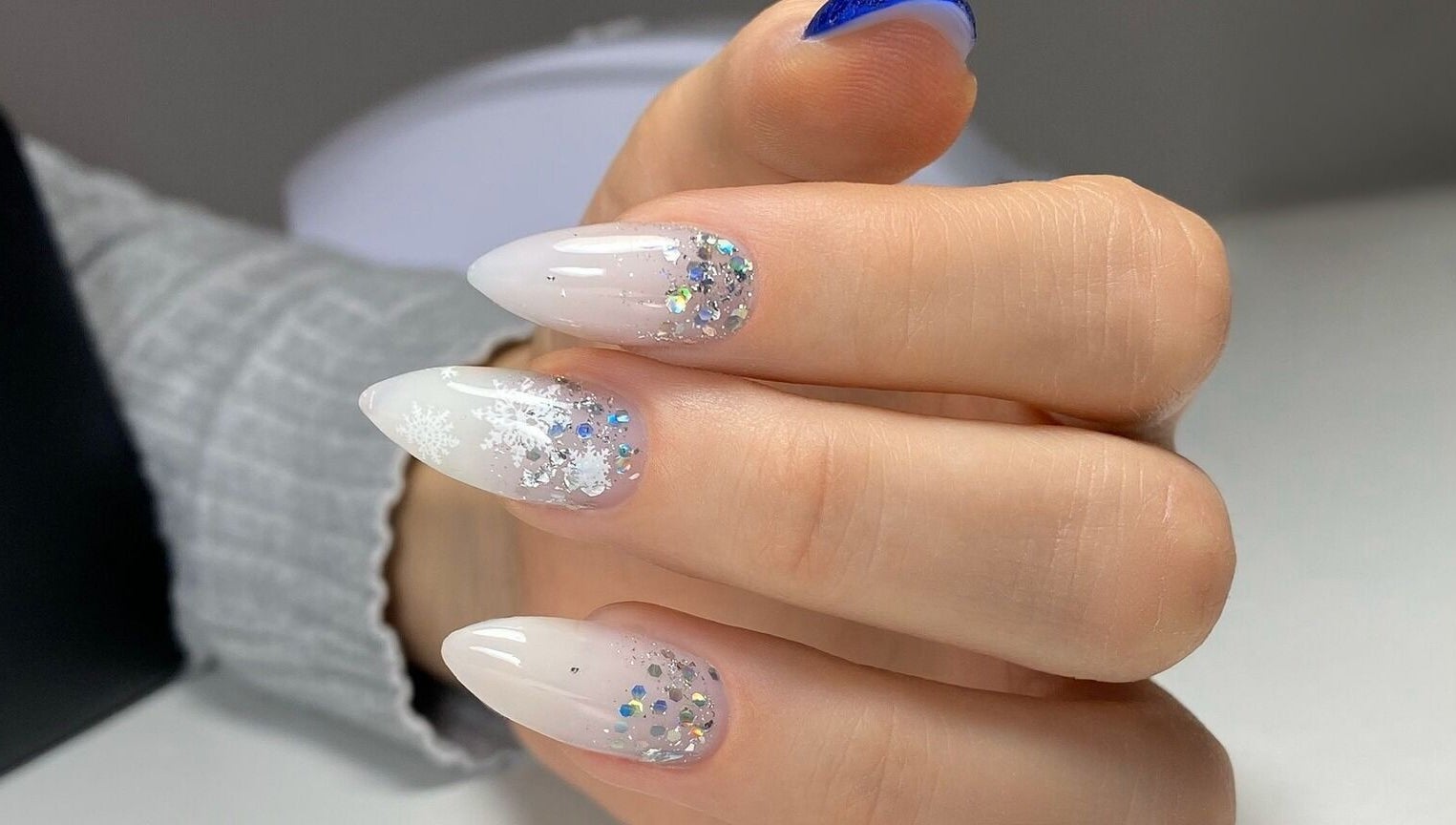 Glittering nail art design at MoJo Nails, Eden Prairie, Minnesota, US, showcasing snowflake and crystal details.