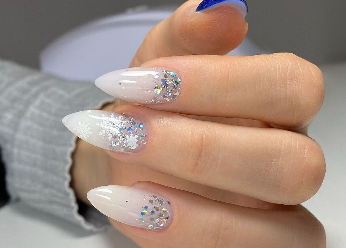 Glittering nail art design at MoJo Nails, Eden Prairie, Minnesota, US, showcasing snowflake and crystal details.