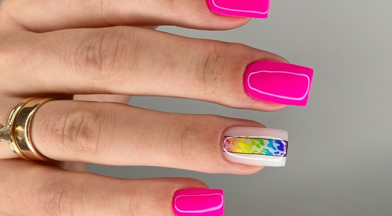 Bright pink and rainbow nail art at MoJo Nails, Eden Prairie, Minnesota, US. Stunning and colorful designs.