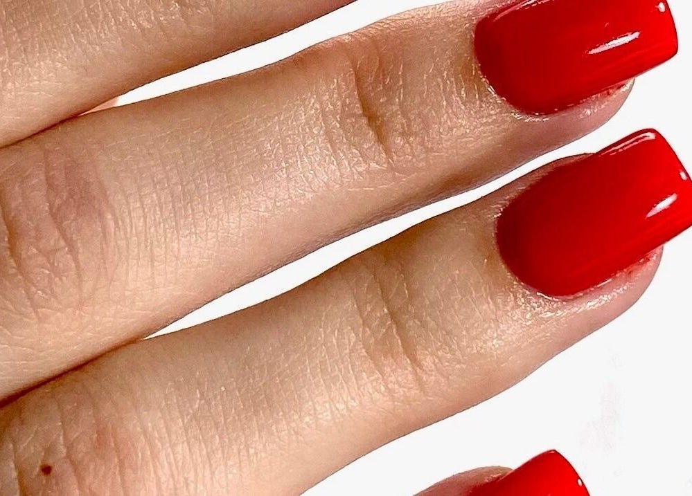 Vibrant red nails by MoJo Nails in Eden Prairie, Minnesota, US, showcasing expert manicure artistry.