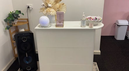 Reception area at Goddess Glow Salon, Melbourne, Victoria, AU with elegant decor and beauty products.