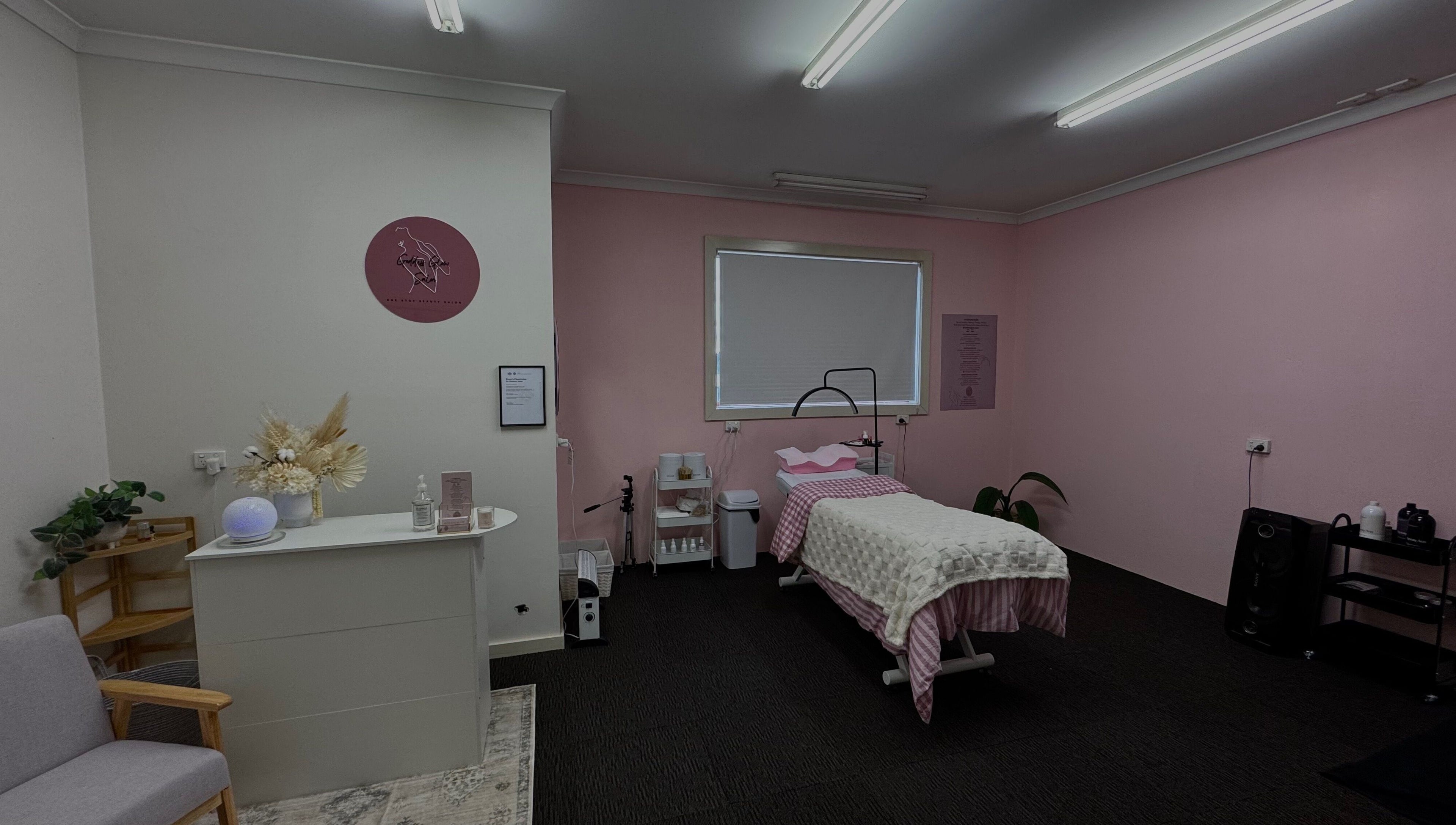 Tranquil therapy room at Goddess Glow Salon in Melbourne, Victoria, AU with pink walls and a cozy treatment bed.