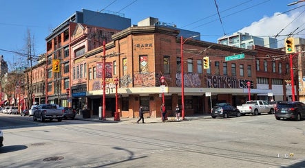 Street view of Marc Revita - New Shanghai Barbershop at a busy Vancouver intersection, British Columbia, CA.