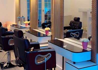 Stylish interior of La Vie en Beauty salon in Bristol, England, GB with modern chairs and mirrors.