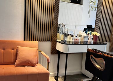 Styled interior of La Vie en Beauty, Bristol, England. Features a peach sofa and modern styling station.