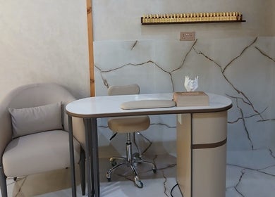 Chic nail station at Velvet Glow Ladies Salon in Dubai, Dubai, AE, featuring luxury seating and modern decor.