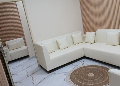 Elegant lounge area in Velvet Glow Ladies Salon, Dubai, Dubai, AE with white sofas and wooden accents.