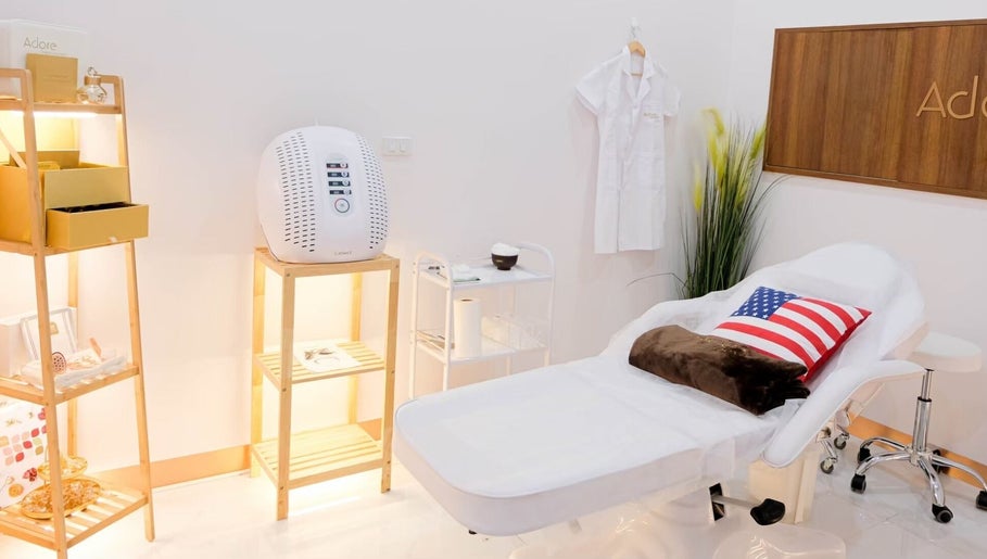 Tranquil spa room at Adore Cosmetics, Krung Thep Maha Nakhon, featuring a cozy treatment bed and modern decor.
