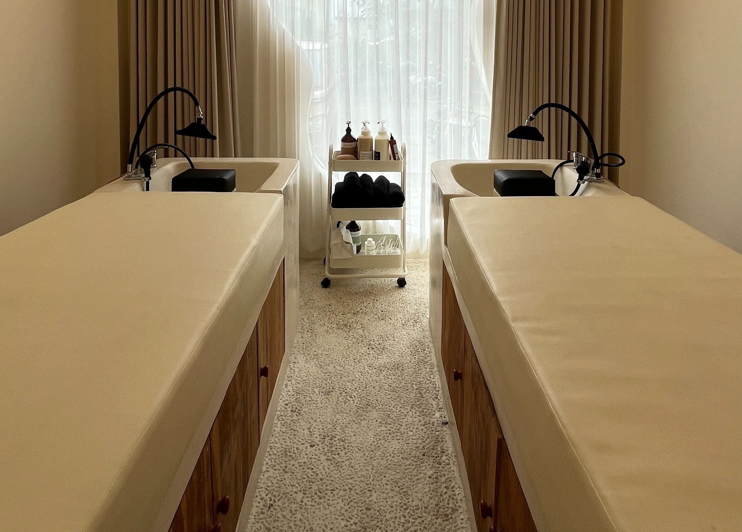 Elegant treatment room at The Pause Hair Salon and Head Spa, Bali, Bali, ID, featuring luxurious twin beds.