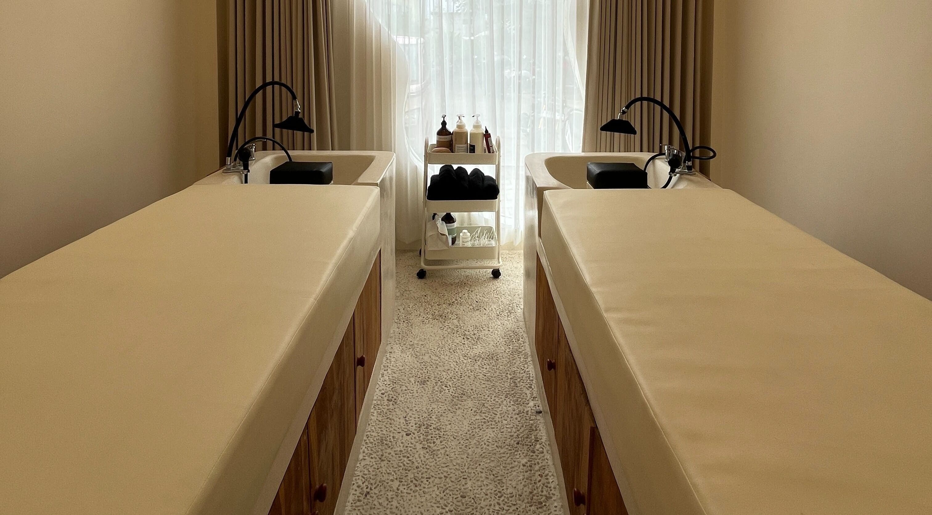 Elegant treatment room at The Pause Hair Salon and Head Spa, Bali, Bali, ID, featuring luxurious twin beds.