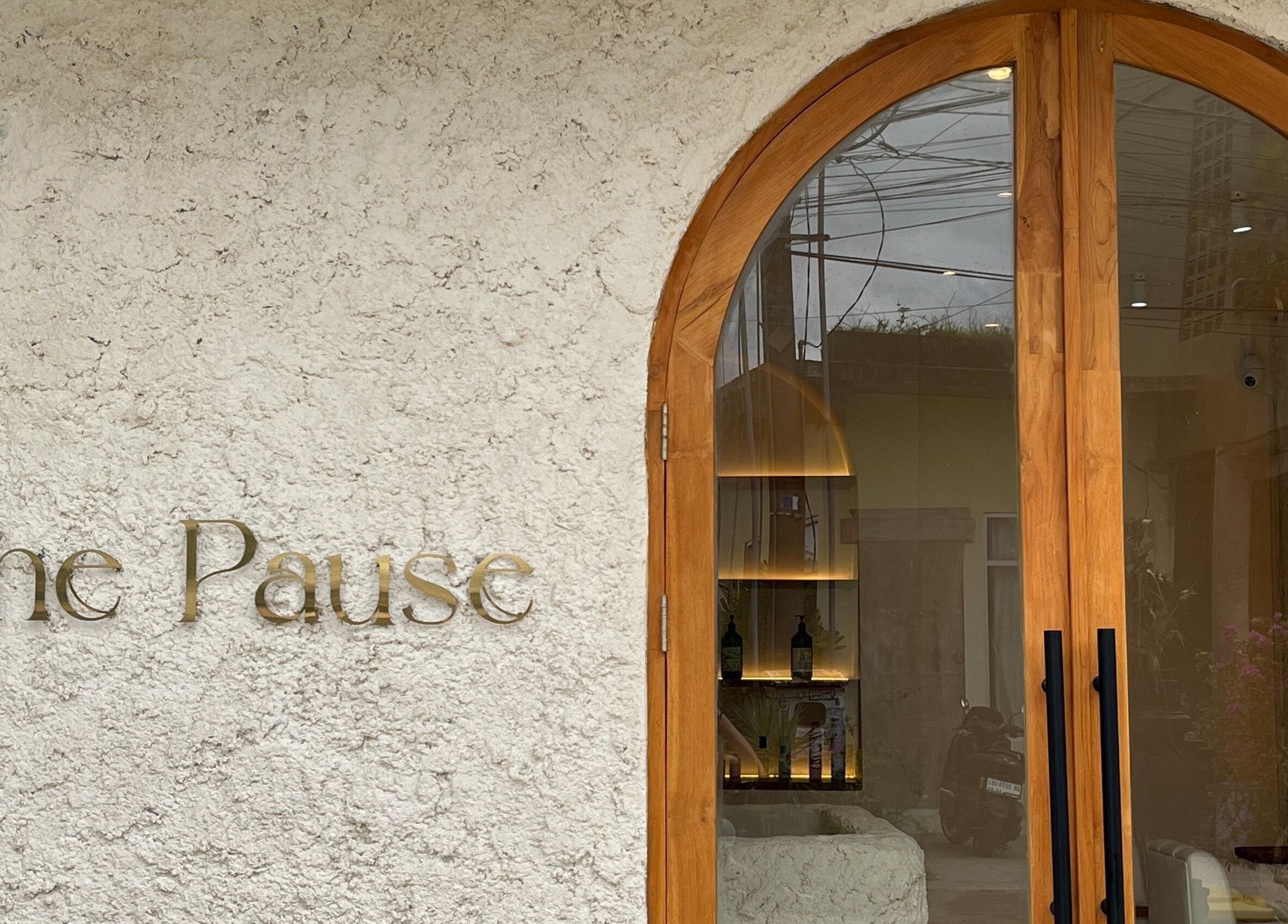 Entrance of The Pause Hair Salon and Head Spa in Bali, Bali, ID featuring elegant wooden doors.