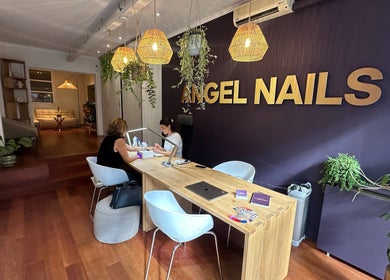 Interior of Angel Nails in Uccle, Bruxelles, BE showing a stylish nail service area with plants.