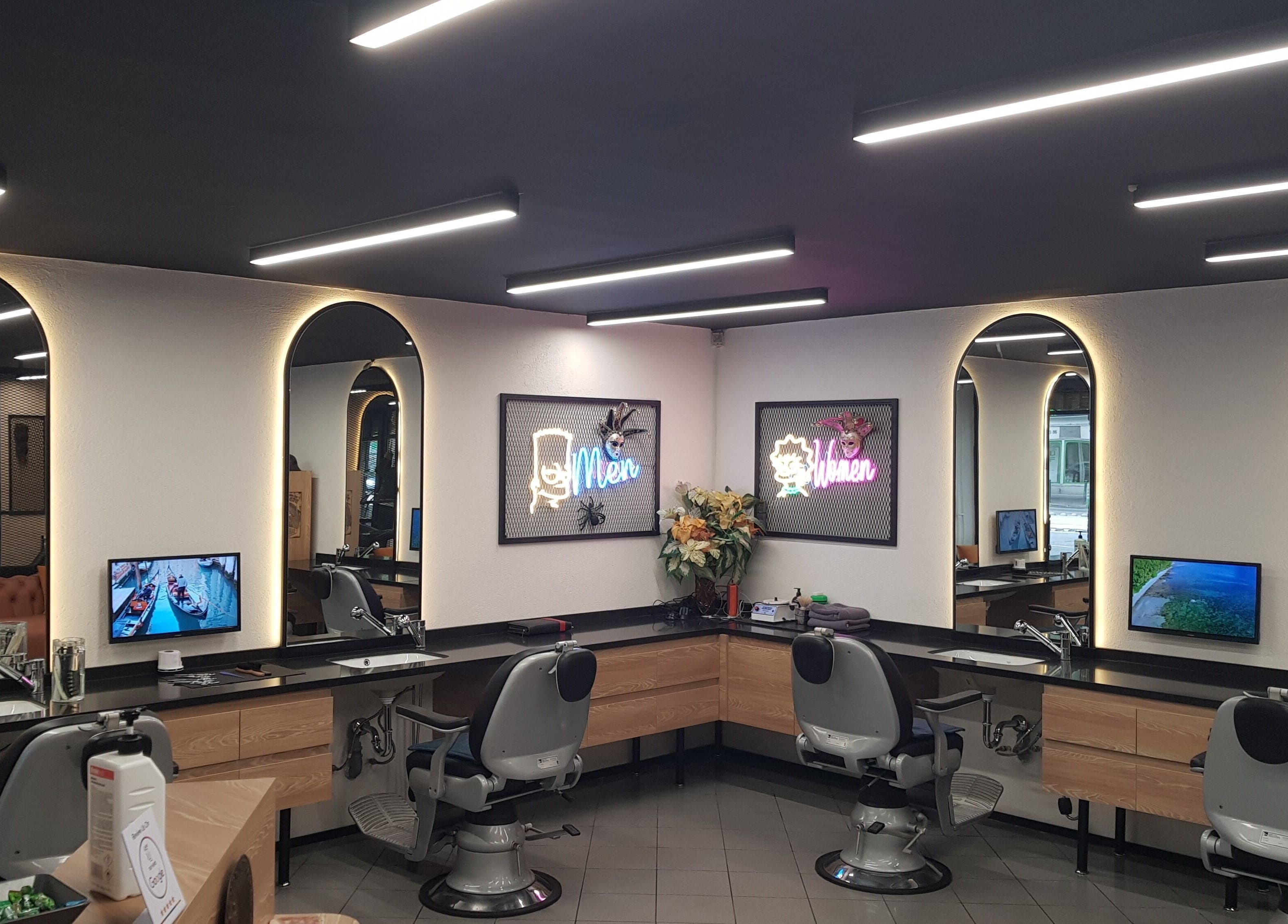 Sleek interior of CADDE34hair salon, Budapest, Magyar, HU with modern lighting and styling stations.