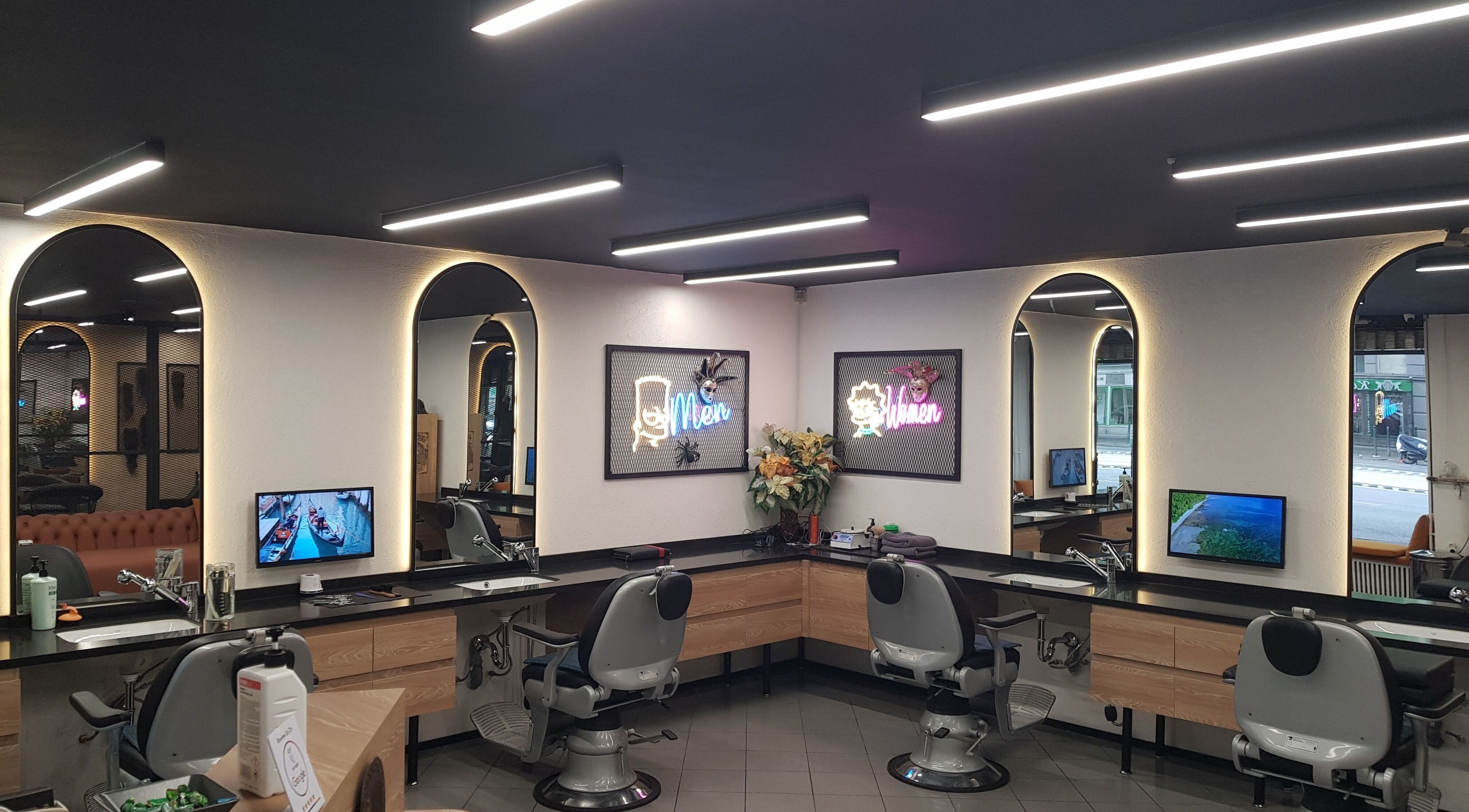 Sleek interior of CADDE34hair salon, Budapest, Magyar, HU with modern lighting and styling stations.