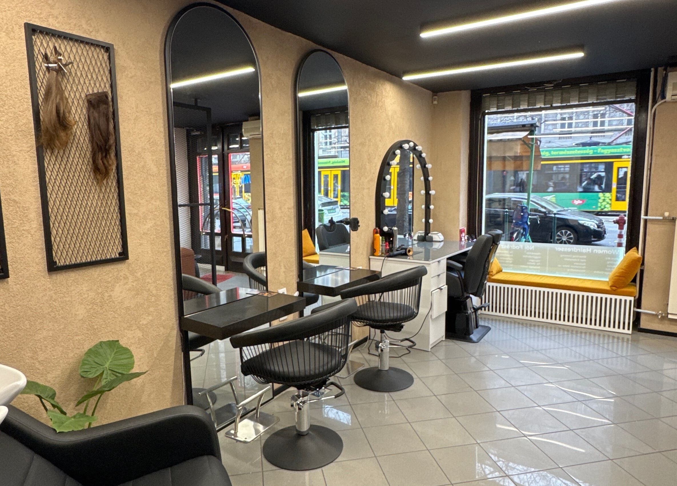 Modern interior of CADDE34hair salon in Budapest, Magyar, HU with styling stations and mirrors.