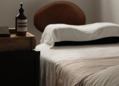 Calm treatment room at Ember Lash, Lilyfield, New South Wales, AU, featuring cozy bedding and essential oils.