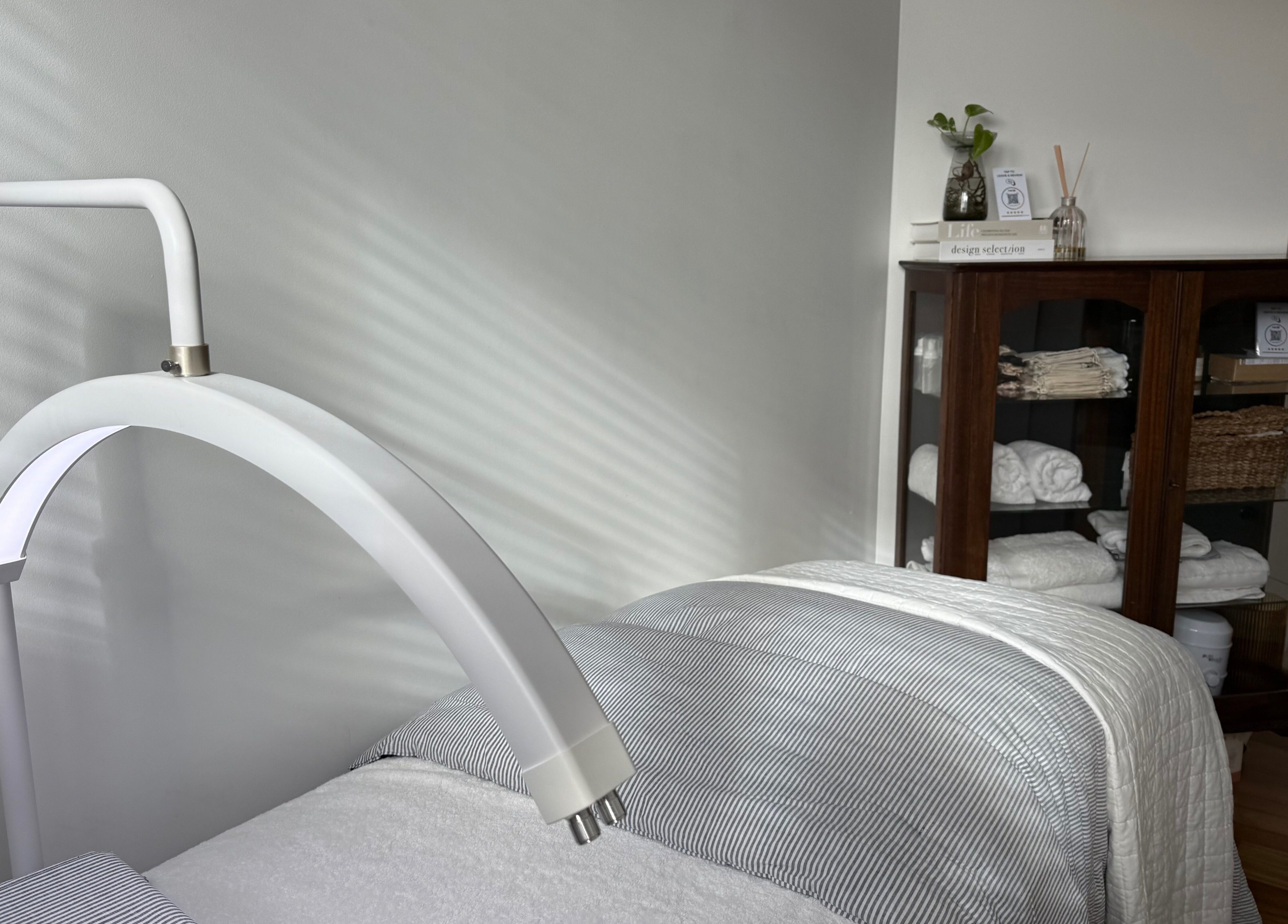 Relaxing treatment room at Ember Lash in Lilyfield, New South Wales, AU, featuring cozy bedding and modern decor.