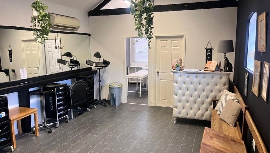 Stylish interior of Gloss&Glam Tamworth in Tamworth, England, GB with modern seating and elegant decor.