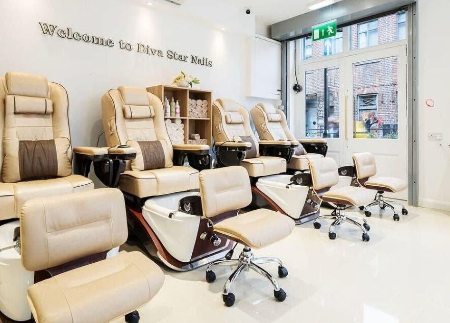 Luxurious nail salon chairs inside Diva Star Nails, London, England, GB, offering premium relaxation.