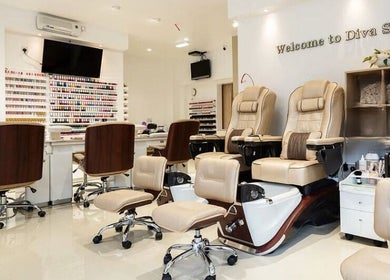 Elegant interior of Diva Star Nails salon in London, England, GB showcasing pedicure chairs and nail polish display.