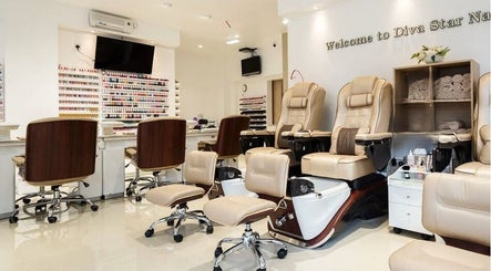 Elegant interior of Diva Star Nails salon in London, England, GB showcasing pedicure chairs and nail polish display.