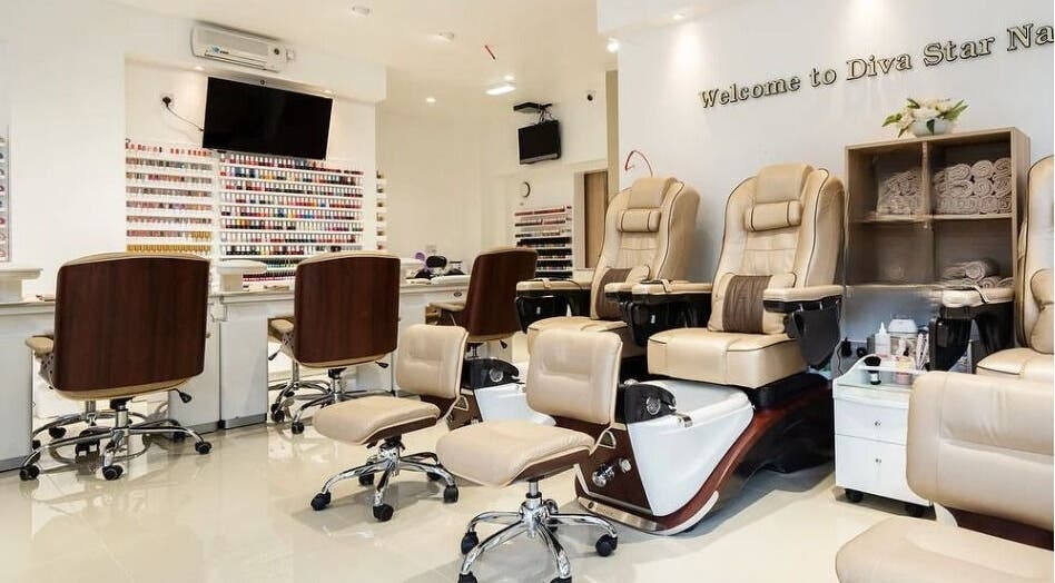Elegant interior of Diva Star Nails salon in London, England, GB showcasing pedicure chairs and nail polish display.