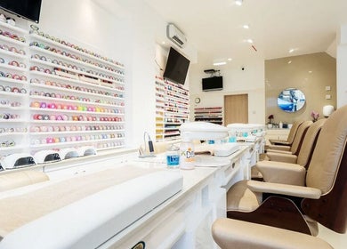 Interior of Diva Star Nails, London, England, GB, showcasing manicure tables and colorful polish display.