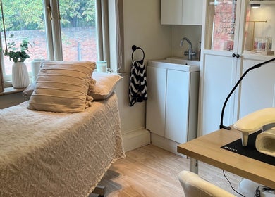Cozy spa room at Rosie’s Retreat in Barton-under-needwood, England, GB, featuring a treatment bed and relaxing decor.