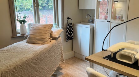 Cozy spa room at Rosie’s Retreat in Barton-under-needwood, England, GB, featuring a treatment bed and relaxing decor.