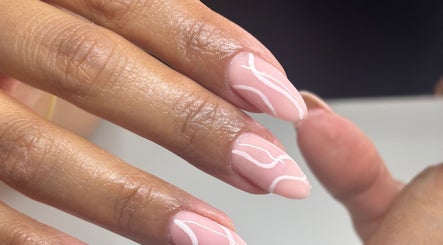 Intricate nail design at NAIL’D IT by khushi in Leicester, England, GB showcasing delicate white patterns.