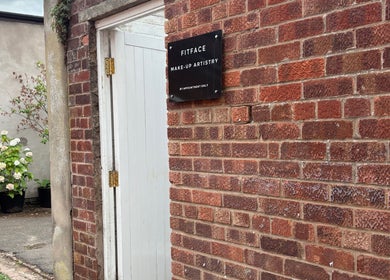 Entrance to Molly Freya Beauty, Royal Leamington Spa, England, with brick wall and Fitface sign.