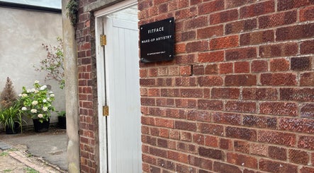 Entrance to Molly Freya Beauty, Royal Leamington Spa, England, with brick wall and Fitface sign.