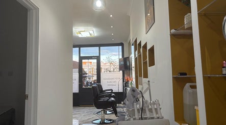 Modern salon interior at Noshi’s beauty hub & Academy, showcasing stylist chairs in London, England, GB.