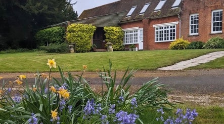 Charming garden view at Stripped Beauty, Basingstoke, England, GB featuring vibrant flowers and traditional architecture.