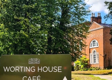 Elegant venue front at Stripped Beauty in Basingstoke, England, enhanced by lush greenery and a classic facade.