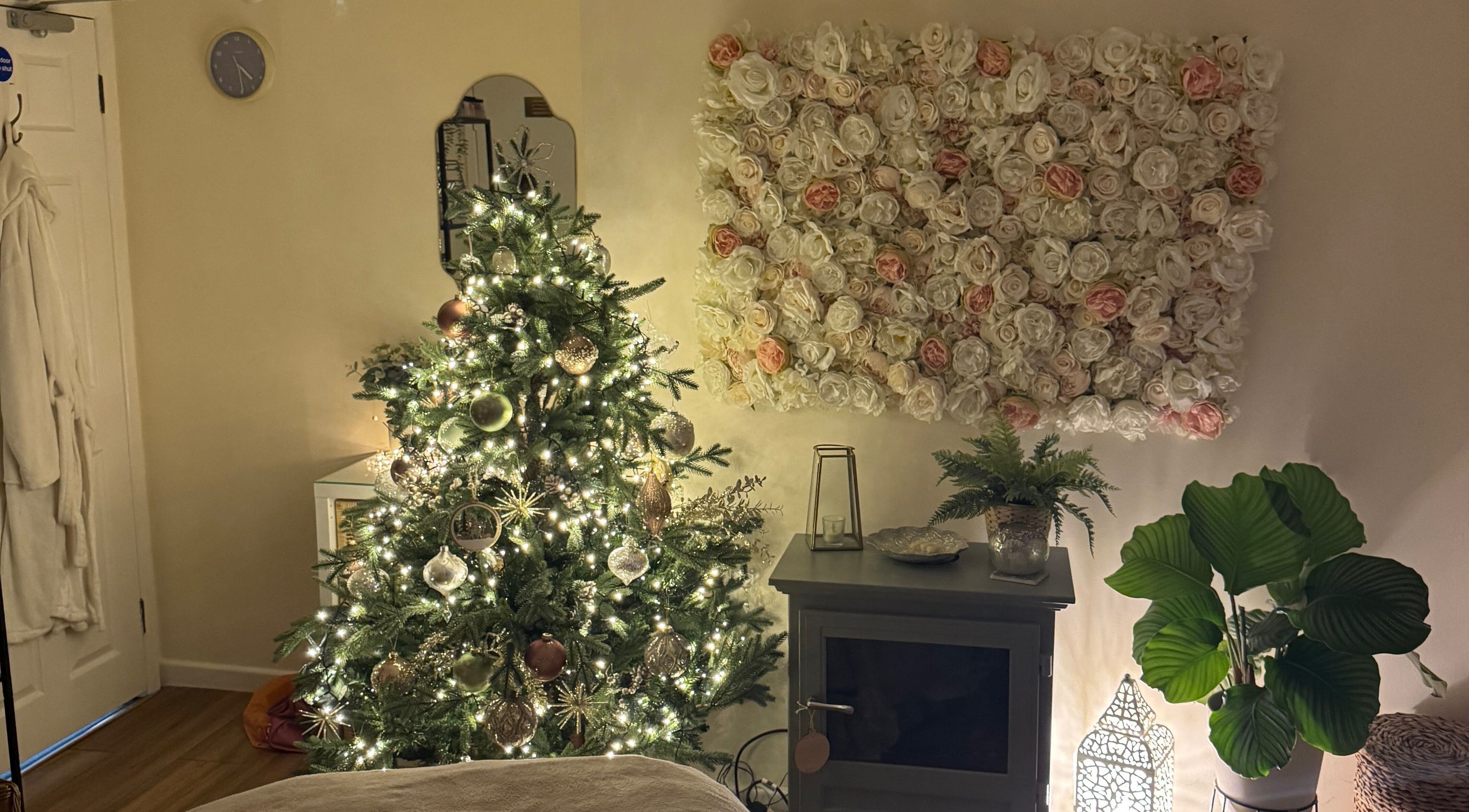 Elegant room at Stripped Beauty Basingstoke, England, GB with festive tree and floral decor.