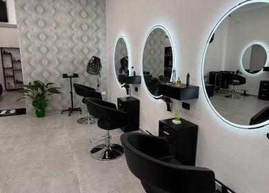 Interno moderno di Sb_HairStudio con specchi illuminati a Cimitile, Campania, IT.