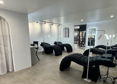 Chic lash lounge at Artistry By Angharad, Rosebery, New South Wales, AU with modern black recliners.
