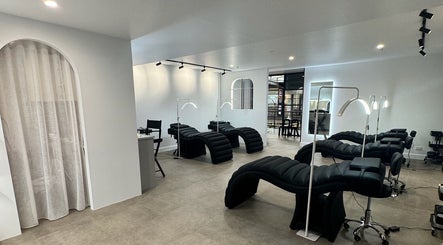 Chic lash lounge at Artistry By Angharad, Rosebery, New South Wales, AU with modern black recliners.