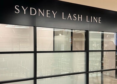 Entrance of Artistry By Angharad at Sydney Lash Line, Rosebery, New South Wales, AU showcasing elegant glass facade.