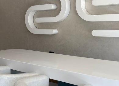 Modern reception desk at Skin & Sage, Cape Town, Western Cape, ZA with stylish wall art.