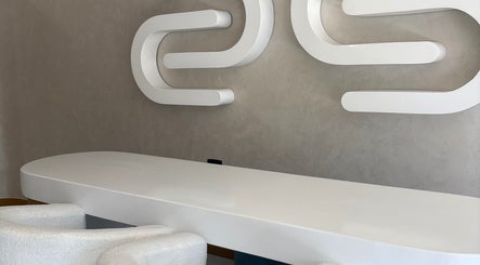 Modern reception desk at Skin & Sage, Cape Town, Western Cape, ZA with stylish wall art.