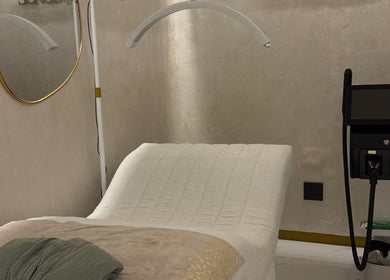 Luxurious treatment room at Skin & Sage, Cape Town, Western Cape, ZA, featuring a plush bed and modern equipment.
