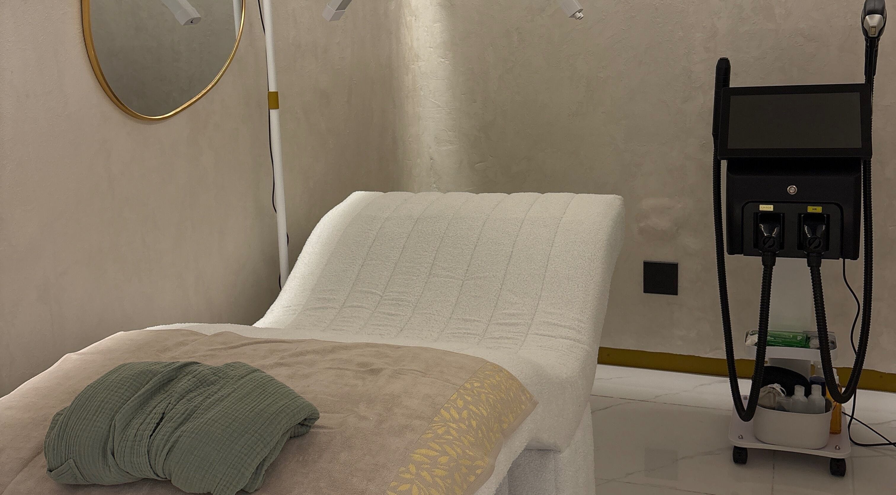 Luxurious treatment room at Skin & Sage in Cape Town, Western Cape, ZA with modern equipment and cozy bed.