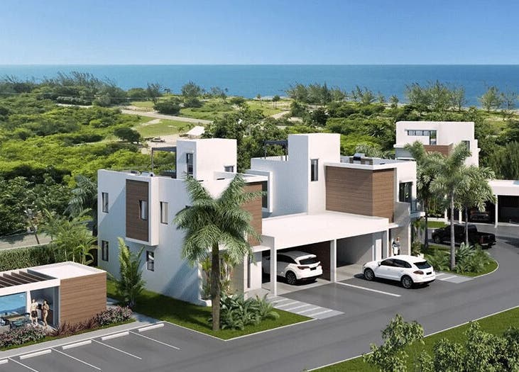 Contemporary buildings near lush greenery and sea at Isla Luxe Lashes, George Town, George Town, KY.